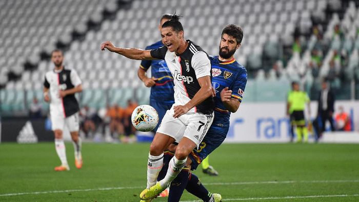 Juventus vs Lecce TURIN, ITALY - JUNE 26: Cristiano Ronaldo of Juventus is tackled by Luca Rossettini of US Lecce during the Serie A match between Juventus and US Lecce at Allianz Stadium on June 26, 2020 in Turin, Italy. (Photo by Valerio Pennicino/Getty Images)