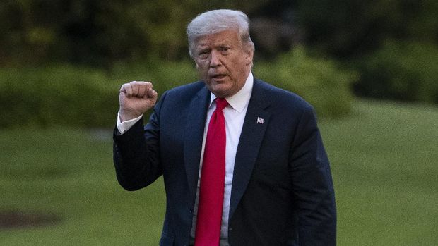 President Donald Trump pumps his fist as he walks on the South Lawn after arriving on Marine One at the White House, Thursday, June 25, 2020, in Washington. Trump is returning from Wisconsin. (AP Photo/Alex Brandon)