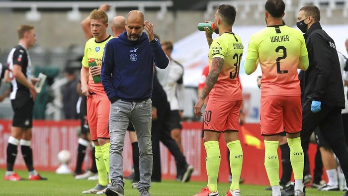 Manchester Citys head coach Pep Guardiola reacts during a drinks break during the FA Cup sixth round soccer match between Newcastle United and Manchester City at St. James Park in Newcastle, England, Sunday, June 28, 2020. (Owen Humphreys/Pool via AP)