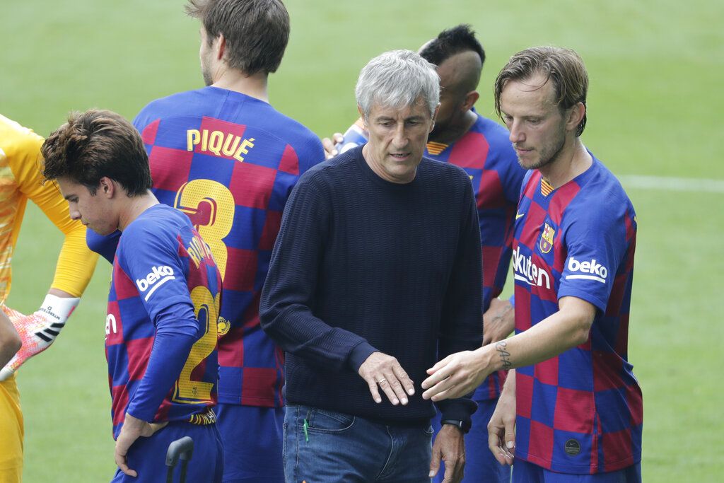 Barcelona's head coach Quique Setien, center, talks with Barcelona's Ivan Rakitic during a Spanish La Liga soccer match between RC Celta and Barcelona at the Balaidos stadium in Vigo, Spain, Saturday, June 27, 2020. (AP Photo/Lalo Villar)