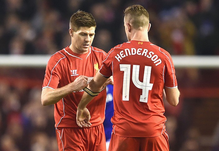 LIVERPOOL, ENGLAND - JANUARY 20:  Steven Gerrard of Liverpool hands the Captains arm band over to Jordan Henderson of Liverpool during the Capital One Cup Semi-Final first leg match between Liverpool and Chelsea at Anfield on January 20, 2015 in Liverpool, England.  (Photo by Michael Regan/Getty Images)