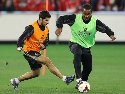 MELBOURNE, AUSTRALIA - JULY 23: Luis Suarez (L) and Andre Wisdom contest for the ball during a Liverpool FC training session at Melbourne Cricket Ground on July 23, 2013 in Melbourne, Australia. (Photo by Michael Dodge/Getty Images)