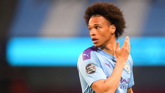 Leroy Sane MANCHESTER, ENGLAND - JUNE 22: Leroy Sane of Manchester City looks on while showing the Black Lives Matter movement logo on his shirt sleeve during the Premier League match between Manchester City and Burnley FC at Etihad Stadium on June 22, 2020 in Manchester, England. Football stadiums around Europe remain empty due to the Coronavirus Pandemic as Government social distancing laws prohibit fans inside venus resulting in all fixtures being played behind closed doors. (Photo by Michael Regan/Getty Images)