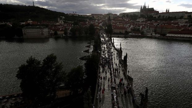 Residents sit to dine on a 500 meter long table set on the medieval Charles Bridge, after restrictions were eased following the coronavirus pandemic in Prague, Czech Republic, Tuesday, June 30, 2020. (AP Photo/Petr David Josek)