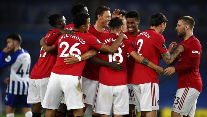 Manchester United players celebrate the second goal of their team during the English Premier League soccer match between Brighton & Hove Albion and Manchester United at the AMEX Stadium in Brighton, England, Tuesday, June 30, 2020. (Mike Hewitt/Pool via AP)