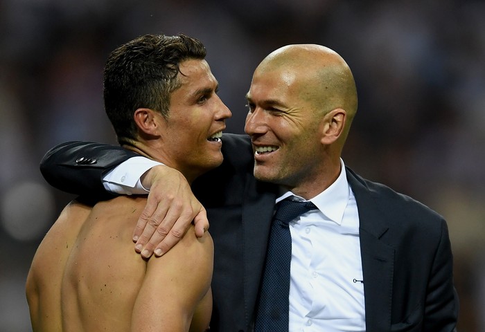 MILAN, ITALY - MAY 28:  Real Madrid head coach Zinedine Zidane hugs a smiling Cristiano Ronaldo of Real Madrid after the UEFA Champions League Final match between Real Madrid and Club Atletico de Madrid at Stadio Giuseppe Meazza on May 28, 2016 in Milan, Italy.  (Photo by Laurence Griffiths/Getty Images)