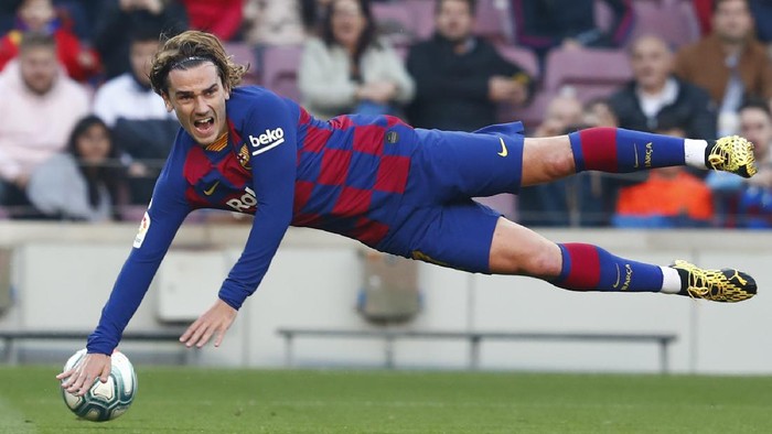 FILE - In this file photo dated Saturday Feb. 22, 2020, Barcelonas Antoine Griezmann falls during a Spanish La Liga soccer match against Eibar at the Camp Nou stadium in Barcelona, Spain.  Griezmann arrived to Camp Nou last summer with the task of completing an intimidating strike trio with Messi and Suárez, but one year later, the French world champion can barely get on the pitch, and was left out of Barcelona’s starting 11 on Tuesday June 30, 2020.  (AP Photo/Joan Monfort, FILE)