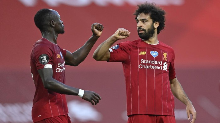 Liverpools Mohamed Salah, right, celebrates after scoring the second goal with Sadio Mane during the English Premier League soccer match between Liverpool and Crystal Palace at Anfield Stadium in Liverpool, England, Wednesday, June 24, 2020. (Paul Ellis/Pool via AP)