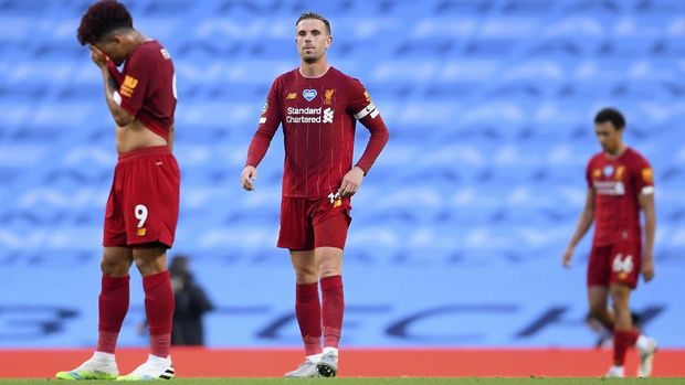 Liverpool's Jordan Henderson, centre, reacts during the English Premier League soccer match between Manchester City and Liverpool at Etihad Stadium in Manchester, England, Thursday, July 2, 2020. (AP Photo/Laurence Griffiths,Pool)