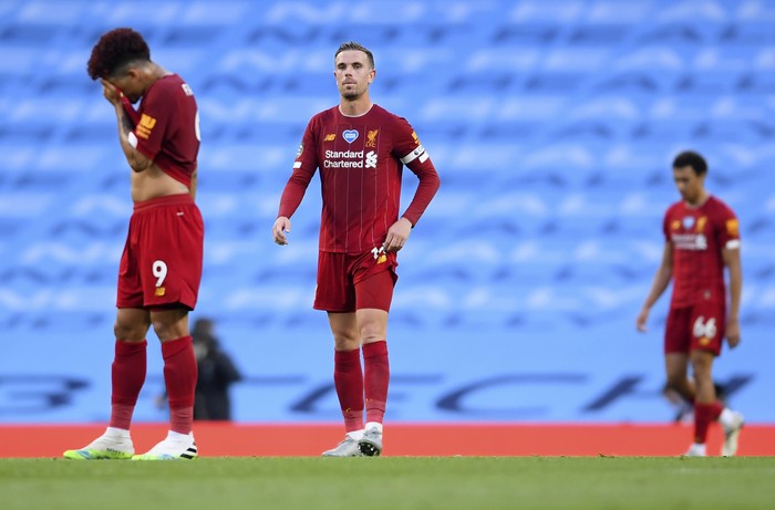 Liverpools Jordan Henderson, centre, reacts during the English Premier League soccer match between Manchester City and Liverpool at Etihad Stadium in Manchester, England, Thursday, July 2, 2020. (AP Photo/Laurence Griffiths,Pool)