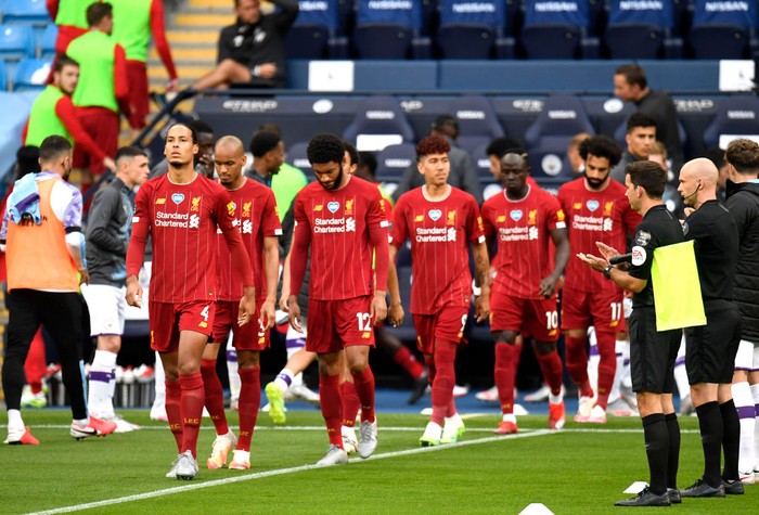 MANCHESTER, ENGLAND - JULY 02: Virgil van Dijk of Liverpool walks out as the Manchester City team create a guard of honor for him and his Liverpool team mates prior to the Premier League match between Manchester City and Liverpool FC at Etihad Stadium on July 02, 2020 in Manchester, England. Football Stadiums around Europe remain empty due to the Coronavirus Pandemic as Government social distancing laws prohibit fans inside venues resulting in all fixtures being played behind closed doors. (Photo by Peter Powell/Pool via Getty Images)