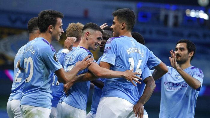 Manchester City Manchester Citys Phil Foden, centre, is congratulated by teammates after scoring his teams third goal during the English Premier League soccer match between Manchester City and Liverpool at Etihad Stadium in Manchester, England, Thursday, July 2, 2020. (AP Photo/Dave Thompson,Pool)