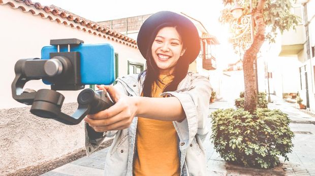 Happy asian woman vlogging with gimbal tripod and smartphone - Influencer chinese girl having fun with new trend technology - Millennial generation activity job, youth and tech concept - Focus on face