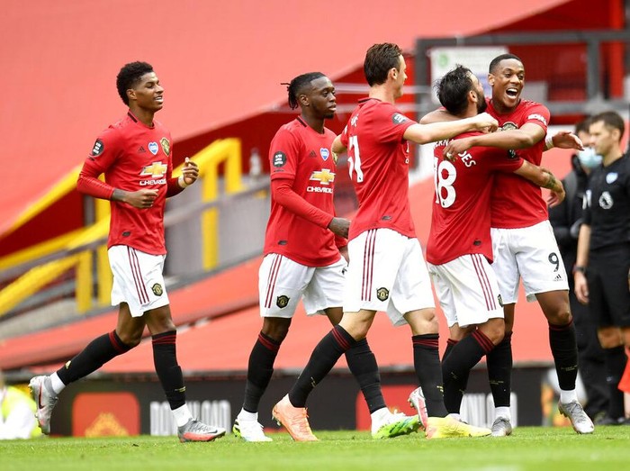 Manchester Uniteds Anthony Martial (9) is congratulated by teammates after scoring a goal during the English Premier League soccer match between Manchester United and Bournemouth at Old Trafford stadium in Manchester, England, Saturday, July 4, 2020. (Peter Powell/Pool via AP)