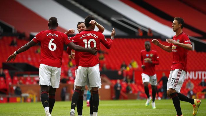 Manchester United MANCHESTER, ENGLAND - JULY 04: Mason Greenwood of Manchester United celebrates with teammates Paul Pogba, Bruno Fernandes and Nemanja Matic of Manchester United after scoring his teams second goal from the penalty spot during the Premier League match between Manchester United and AFC Bournemouth at Old Trafford on July 04, 2020 in Manchester, England. Football Stadiums around Europe remain empty due to the Coronavirus Pandemic as Government social distancing laws prohibit fans inside venues resulting in all fixtures being played behind closed doors. (Photo by Clive Brunskill/Getty Images)