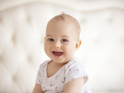 childhood, babyhood and people concept - portrait of joyful baby boy.