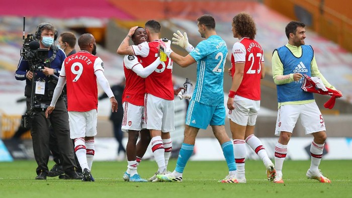 WOLVERHAMPTON, ENGLAND - JULY 04: Eddie Nketiah hugs team mate Granit Xhaka of Arsenal following the Premier League match between Wolverhampton Wanderers and Arsenal FC at Molineux on July 04, 2020 in Wolverhampton, England. Football Stadiums around Europe remain empty due to the Coronavirus Pandemic as Government social distancing laws prohibit fans inside venues resulting in all fixtures being played behind closed doors. (Photo by Catherine Ivill/Getty Images)
