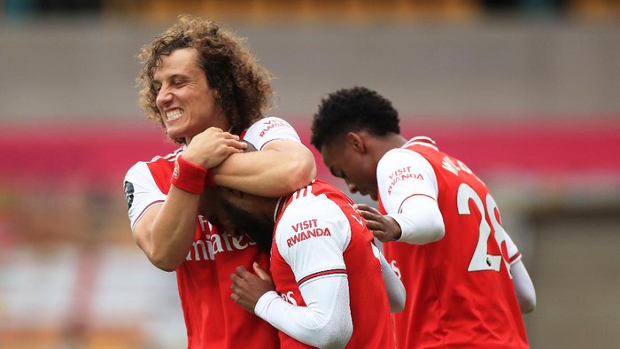 WOLVERHAMPTON, ENGLAND - JULY 04: Alexandre Lacazette of Arsenal celebrates with teammate David Luiz after scoring his teams second goal during the Premier League match between Wolverhampton Wanderers and Arsenal FC at Molineux on July 04, 2020 in Wolverhampton, England. Football Stadiums around Europe remain empty due to the Coronavirus Pandemic as Government social distancing laws prohibit fans inside venues resulting in all fixtures being played behind closed doors. (Photo by Mike Egerton/Pool via Getty Images)