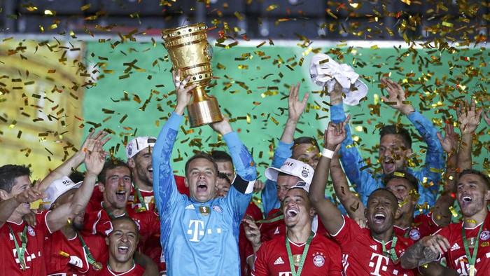 Bayern Munich players celebrate after winning the trophy in the German soccer cup (DFB Pokal) final match between Bayer 04 Leverkusen and FC Bayern Munich in Berlin, Germany, Saturday, July 4, 2020. (AP Photo/Michael Sohn)