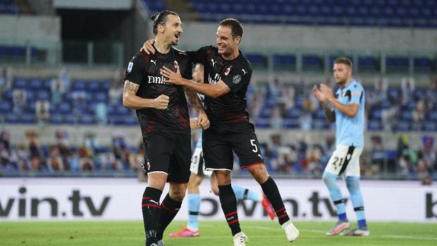 AC Milan's Zlatan Ibrahimovic, left, celebrates with Giacomo Bonaventura after scoring his side's 2nd goal on a penalty, during the Serie A soccer match between Lazio and AC Milan at the Rome Olympic stadium, Saturday, July 4, 2020. (Spada/LaPresse via AP)