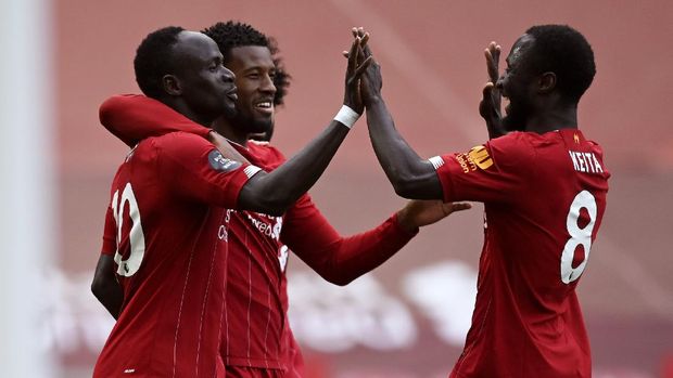 Liverpool's Sadio Mane, left, celebrates after scoring the opening goal during the English Premier League soccer match between Liverpool and Aston Villa at Anfield Stadium in Liverpool, England, Sunday, July 5, 2020. (Shaun Botterill/Pool via AP)