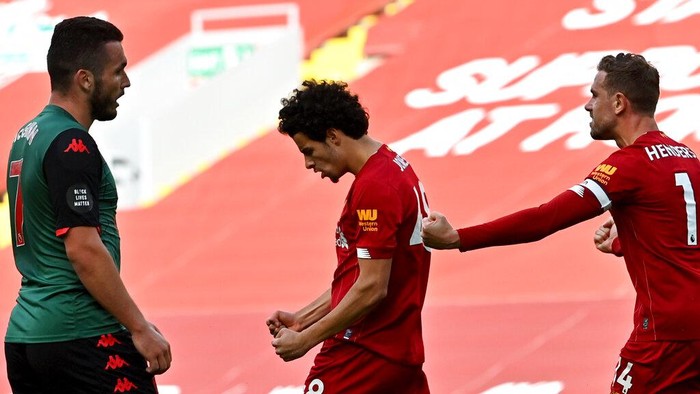 Liverpools Curtis Jones, center, celebrates after scoring his sides second goal during the English Premier League soccer match between Liverpool and Aston Villa at Anfield Stadium in Liverpool, England, Sunday, July 5, 2020. (Paul Ellis/Pool via AP)