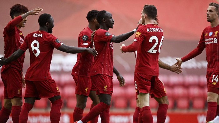 Liverpools Sadio Mane, center, celebrates after scoring the opening goal during the English Premier League soccer match between Liverpool and Aston Villa at Anfield Stadium in Liverpool, England, Sunday, July 5, 2020. (Shaun Botterill/Pool via AP)