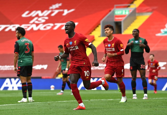 LIVERPOOL, ENGLAND - JULY 05: Sadio Mane of Liverpool celebrates after scoring his teams first goal during the Premier League match between Liverpool FC and Aston Villa at Anfield on July 05, 2020 in Liverpool, England.Football Stadiums around Europe remain empty due to the Coronavirus Pandemic as Government social distancing laws prohibit fans inside venues resulting in games being played behind closed doors. (Photo by Paul Ellis/Pool via Getty Images)