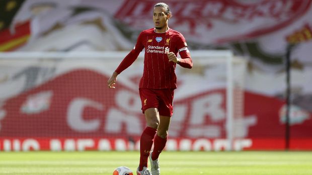 Liverpool's Virgil van Dijk runs with the ball during the English Premier League soccer match between Liverpool and Aston Villa at Anfield Stadium in Liverpool, England, Sunday, July 5, 2020. (Carl Recine/Pool via AP)