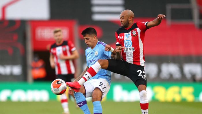 Southampton, manchester city SOUTHAMPTON, ENGLAND - JULY 05: Joao Cancelo of Manchester City is challenged by Nathan Redmond of Southampton during the Premier League match between Southampton FC and Manchester City at St Marys Stadium on July 05, 2020 in Southampton, England. Football Stadiums around Europe remain empty due to the Coronavirus Pandemic as Government social distancing laws prohibit fans inside venues resulting in games being played behind closed doors. (Photo by Catherine Ivill/Getty Images)