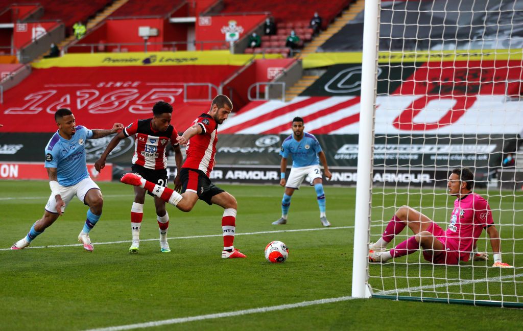 SOUTHAMPTON, ENGLAND - JULY 05: Alex McCarthy of Southampton saves from David Silva of Manchester City during the Premier League match between Southampton FC and Manchester City at St Mary's Stadium on July 05, 2020 in Southampton, England. Football Stadiums around Europe remain empty due to the Coronavirus Pandemic as Government social distancing laws prohibit fans inside venues resulting in games being played behind closed doors. (Photo by Frank Augstein/Pool via Getty Images)