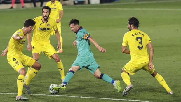 FC Barcelona's Lionel Messi, second right, duels for the ball with Villareal's Pau Torres, left, and Villareal's Raul Albiol, right, during the Spanish La Liga soccer match between FC Barcelona and Villareal at La Ceramica stadium in Villareal, Spain, Sunday, July 5, 2020. (AP Photo/Jose Miguel Fernandez de Velasco)
