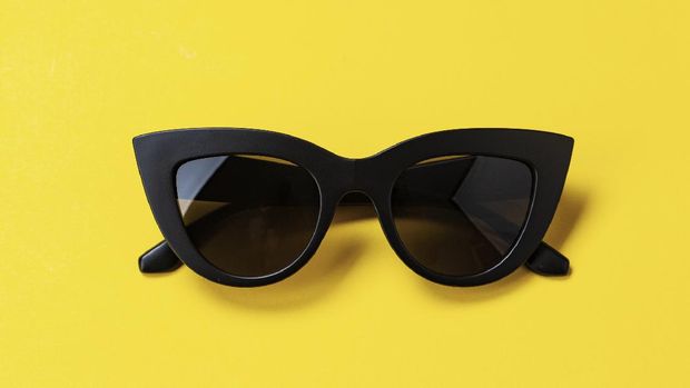 Women's retro sunglasses cat or fox on a bright yellow background. space for text