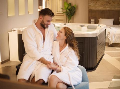 Today we will just enjoy. Young couple in spa apartment.