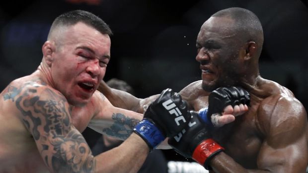 LAS VEGAS, NEVADA - DECEMBER 14: Colby Covington (L) takes a punch from UFC welterweight champion Kamaru Usman in their welterweight title fight during UFC 245 at T-Mobile Arena on December 14, 2019 in Las Vegas, Nevada. Usman retained his title with a fifth-round TKO.   Steve Marcus/Getty Images/AFP