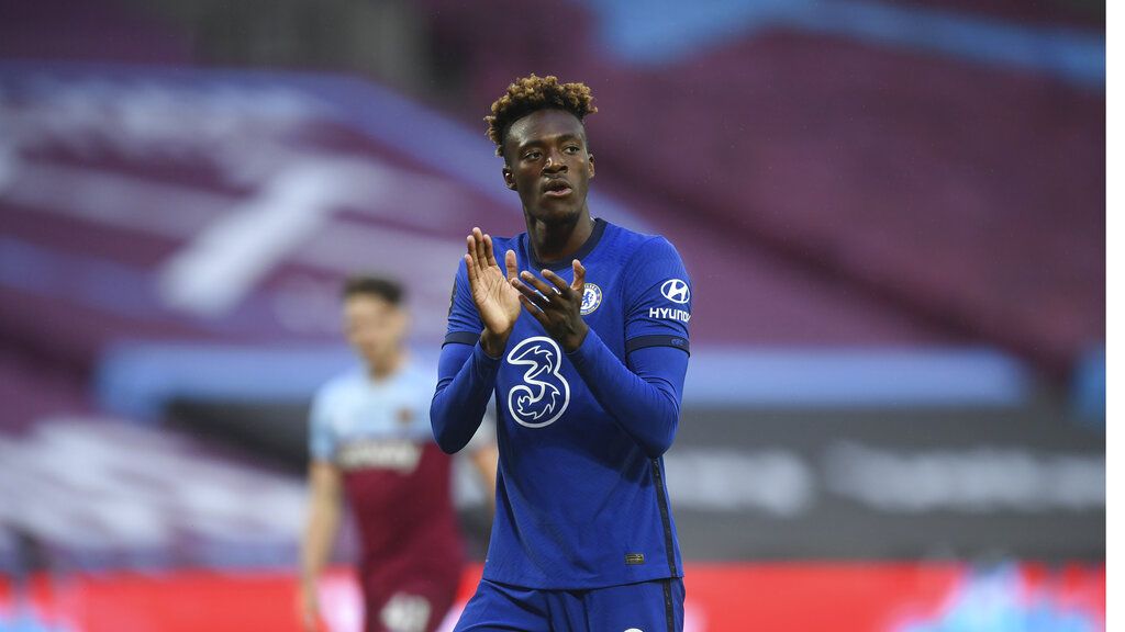 Chelsea's Tammy Abraham, claps his teammates as they wait for the start of theEnglish Premier League soccer match between West Ham United and Chelsea at the London Stadium stadium in London, Wednesday July 1, 2020. (Michael Regan/Pool via AP)