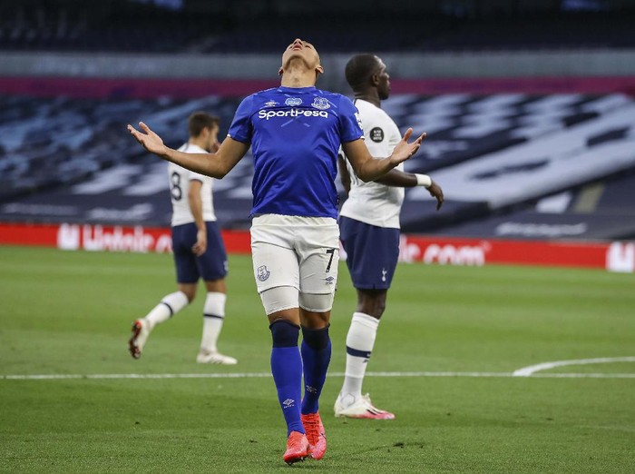 Tottenham players celebrate after scoring the opening goal during the English Premier League soccer match between Tottenham Hotspur and Everton FC at the Tottenham Hotspur Stadium in London, England, Monday, July 6, 2020.(Cath Ivill/Pool via AP)