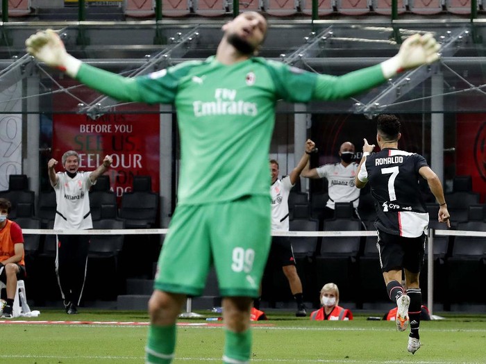 AC Milan's Rafael Leao, left, celebrates with his teammate Ismael Bennacer after scoring his side's 3rd goal during the Serie A soccer match between AC Milan and Juventus at the Milan San Siro Stadium, Italy, Tuesday, July 7, 2020. (Spada/LaPresse via AP)
