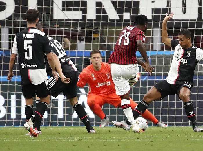 AC Milan's Rafael Leao, left, celebrates with his teammate Ismael Bennacer after scoring his side's 3rd goal during the Serie A soccer match between AC Milan and Juventus at the Milan San Siro Stadium, Italy, Tuesday, July 7, 2020. (Spada/LaPresse via AP)