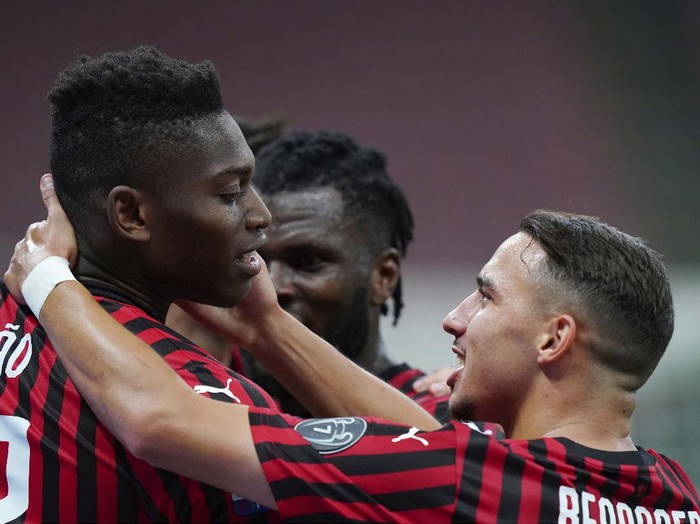 AC Milan's Rafael Leao, left, celebrates with his teammate Ismael Bennacer after scoring his side's 3rd goal during the Serie A soccer match between AC Milan and Juventus at the Milan San Siro Stadium, Italy, Tuesday, July 7, 2020. (Spada/LaPresse via AP)