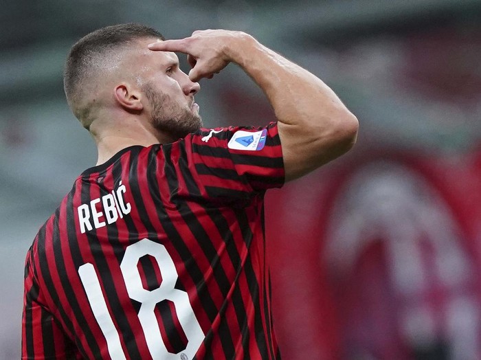 AC Milan's Rafael Leao, left, celebrates with his teammate Ismael Bennacer after scoring his side's 3rd goal during the Serie A soccer match between AC Milan and Juventus at the Milan San Siro Stadium, Italy, Tuesday, July 7, 2020. (Spada/LaPresse via AP)