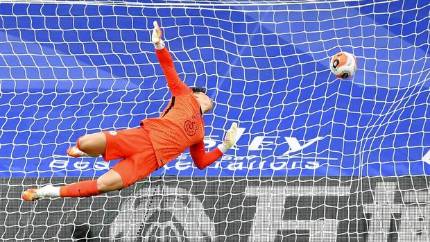 Chelsea's goalkeeper Kepa Arrizabalaga fails to save the ball as Crystal Palace's Wilfried Zaha scores his side's opening goal during the English Premier League soccer match between Crystal Palace and Burnley at Selhurst Park, in London, England, Tuesday, July 7, 2020. (Justin Tallis/Pool via AP)