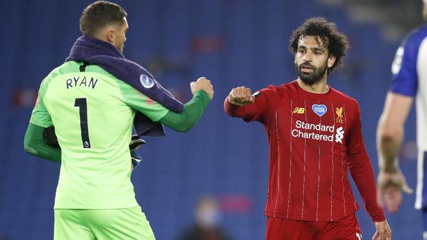 Liverpool's Mohamed Salah, right, gestures with Brighton's goalkeeper Mathew Ryan after the English Premier League soccer match between Brighton and Liverpool at Falmer Stadium in Brighton, England, Wednesday, July 8, 2020. (AP Photo/Paul Childs,Pool)
