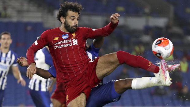 Liverpool's Mohamed Salah attempts to control the ball during the English Premier League soccer match between Brighton and Liverpool at Falmer Stadium in Brighton, England, Wednesday, July 8, 2020. (AP Photo/Catherine Ivill,Pool)