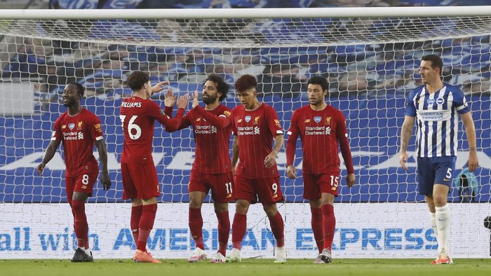 BRIGHTON, ENGLAND - JULY 08: Mohamed Salah of Liverpool celebrates after scoring his teams first goal during the Premier League match between Brighton & Hove Albion and Liverpool FC at American Express Community Stadium on July 08, 2020 in Brighton, England. Football Stadiums around Europe remain empty due to the Coronavirus Pandemic as Government social distancing laws prohibit fans inside venues resulting in all fixtures being played behind closed doors. (Photo by Paul Childs/Pool via Getty Images)