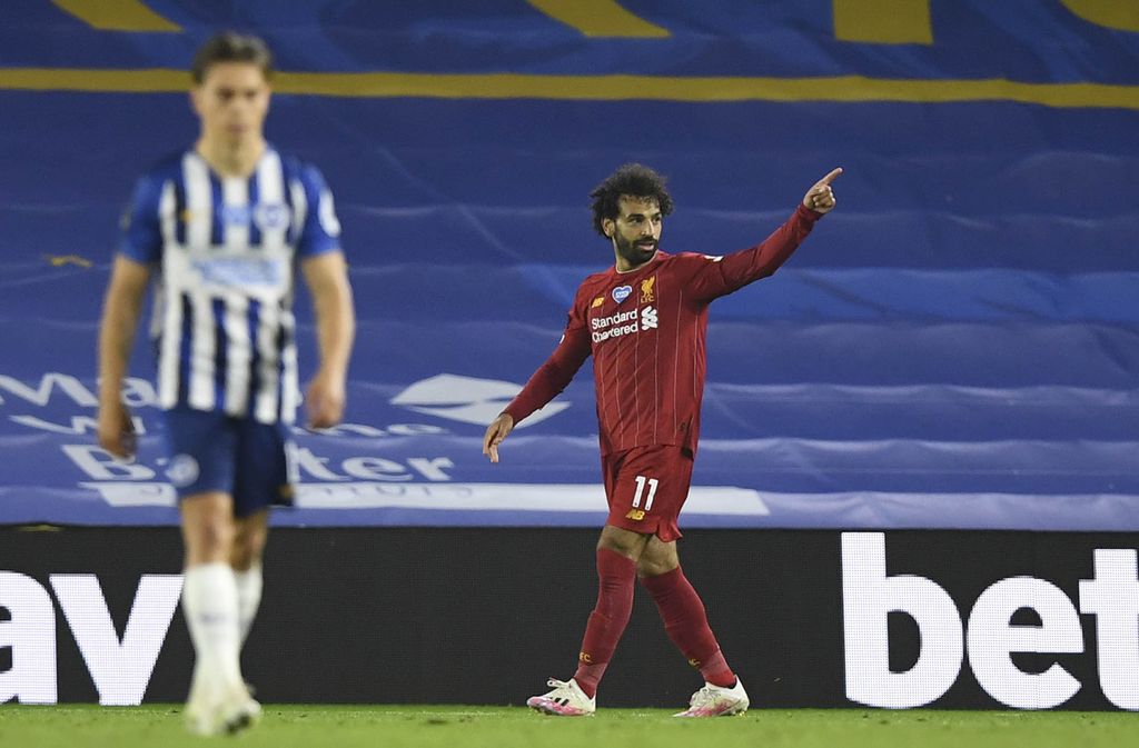 Liverpool's Mohamed Salah reacts after missing a shot at goal during the English Premier League soccer match between Brighton and Liverpool at Falmer Stadium in Brighton, England, Wednesday, July 8, 2020. (AP Photo/Paul Childs,Pool)