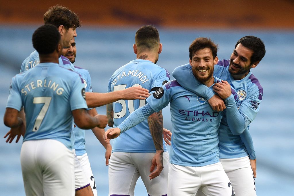 MANCHESTER, ENGLAND - JULY 08: David Silva of Manchester City celebrates with his team after he scores his sides fourth goal from a free kick during the Premier League match between Manchester City and Newcastle United at Etihad Stadium on July 08, 2020 in Manchester, England. Football Stadiums around Europe remain empty due to the Coronavirus Pandemic as Government social distancing laws prohibit fans inside venues resulting in all fixtures being played behind closed doors. (Photo by Oli Scarff/Pool viaGetty Images)