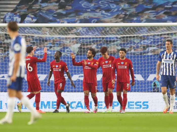 BRIGHTON, ENGLAND - JULY 08: Mohamed Salah of Liverpool celebrates after scoring his teams first goal during the Premier League match between Brighton & Hove Albion and Liverpool FC at American Express Community Stadium on July 08, 2020 in Brighton, England. Football Stadiums around Europe remain empty due to the Coronavirus Pandemic as Government social distancing laws prohibit fans inside venues resulting in all fixtures being played behind closed doors. (Photo by Catherine Ivill/Getty Images)