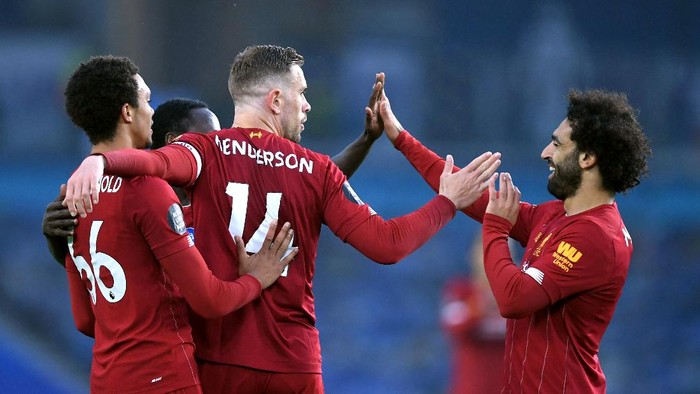 BRIGHTON, ENGLAND - JULY 08: Jordan Henderson of Liverpool celebrates with his team after scoring his sides second goal during the Premier League match between Brighton & Hove Albion and Liverpool FC at American Express Community Stadium on July 08, 2020 in Brighton, England. Football Stadiums around Europe remain empty due to the Coronavirus Pandemic as Government social distancing laws prohibit fans inside venues resulting in all fixtures being played behind closed doors. (Photo by Daniel Leal Olivas/Pool via Getty Images)