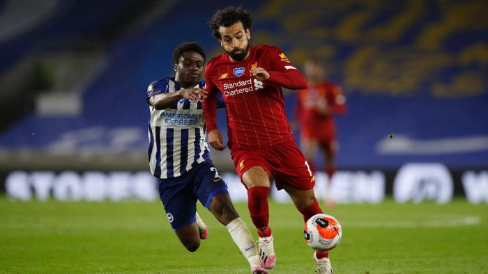 BRIGHTON, ENGLAND - JULY 08: Tariq Lamptey of Brighton and Hove Albion  battles for possession with  Mohamed Salah of Liverpool  during the Premier League match between Brighton & Hove Albion and Liverpool FC at American Express Community Stadium on July 08, 2020 in Brighton, England. Football Stadiums around Europe remain empty due to the Coronavirus Pandemic as Government social distancing laws prohibit fans inside venues resulting in all fixtures being played behind closed doors. (Photo by Paul Childs/Pool via Getty Images)